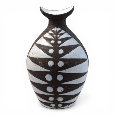 a black and white vase on a white surface
