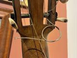 a close up of a guitar with strings attached to it
