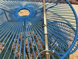 a blue umbrella sitting on top of a green rug
