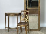 a small table with a mirror and a chair in front of it