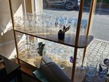 many glasses on the shelves in the room