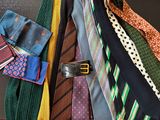 a lot of ties that are hanging on the wall