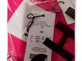 a pink bag with a pair of scissors on it