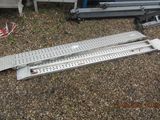 a metal ramp that is laying on the ground