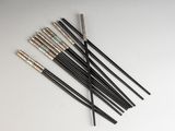 a set of six black and gold arrows on a white surface