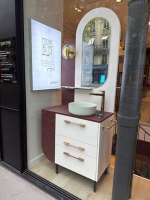 a bathroom with a sink and a mirror in the window