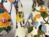 two vases that have been decorated with flowers on them