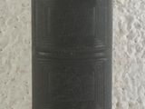 an old book sitting on top of a table next to a wall