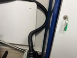 an image of a toilet with a hose attached to it