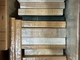 many books stacked on top of each other in a box
