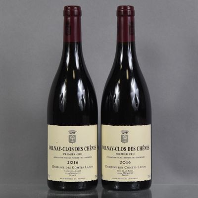 two bottles of wine sitting on top of a table next to each other