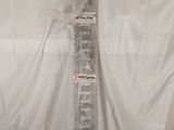 a picture of a television remote control sitting on top of a white sheet