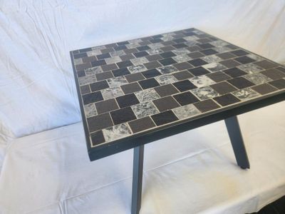a black and white table with a black and white tile top