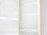 an open book on a table with a white background