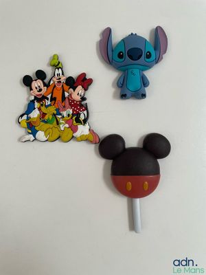 mickey mouse and stitcher characters are on a white surface