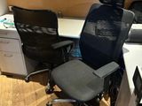 a desk with a chair and a computer on it