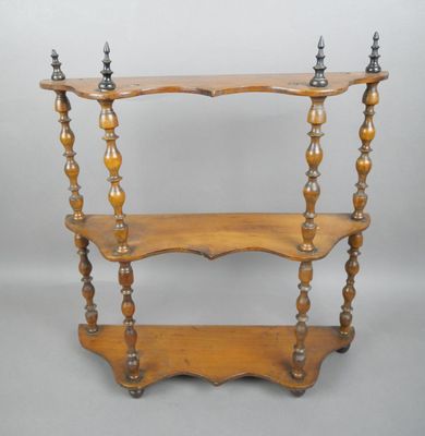 an old wooden shelf with three shelves on top of it