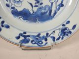 a blue and white plate with a flower design on it