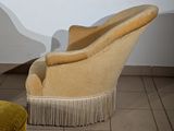 two chairs and a stool in a room with tile flooring