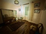 an image of a living room with a chair and a mirror