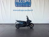 an image of a motorcycle parked in front of a alcoba auction sign