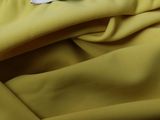 the label on a yellow dress hangs on a white background
