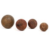 a group of three rusty metal balls sitting next to each other