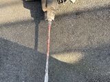 a broken fire hydrant sitting on the ground next to a hose