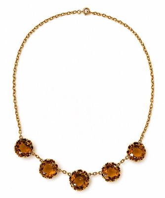 an image of a necklace with orange stones on it