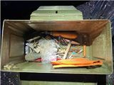 an image of a green trash can filled with items