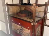 a wooden cabinet with a hat on top of it