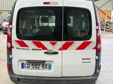 a white van with red stripes parked in a garage