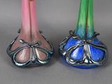 two colorful vases sitting next to each other on a table