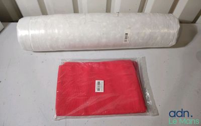 a roll of red tissue next to a roll of white tissue