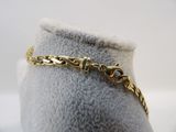 a close up of a gold bracelet on a mannequin mannequin