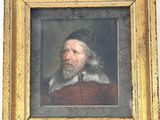 portrait d'un homme barbu dans un cadre doré