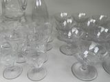 bottles and glasses are lined up on a white table