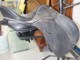 a saddle that is sitting on a stand in a room