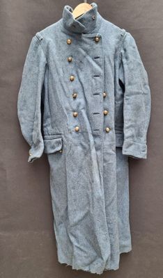 a blue coat on a hanger on a wall
