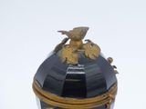 a black and gold box with a bird on it