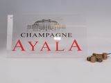 a sign that says champagnee ayala with a bottle of wine next to it