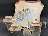 an image of a tea set with a tray and cups