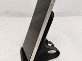 a cell phone that is sitting on top of a stand