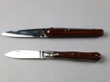 two knives that are sitting next to each other on a table