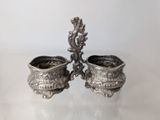 pair of antique silverplated sugar and butter dishes on a white surface