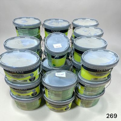 many buckets of tennis balls sitting on a table