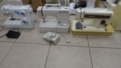 many different types of sewing machines sitting on the floor