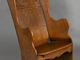 an old wooden rocking chair with a carved back and seat