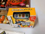 a box of games and a game controller on a table