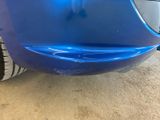 a close up of a blue car that has been painted
